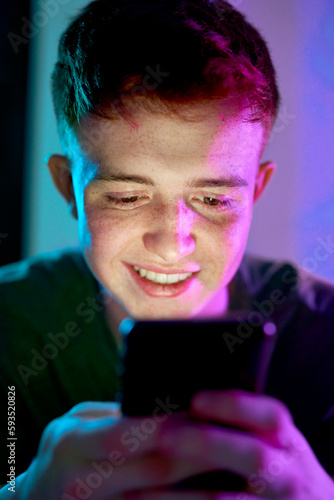 Happy young man surfing net using smart phone