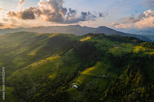 Amazing morning fog in the mountains. Beautiful sunrise light shines on the red beech forest. Drone panorama. © Ryzhkov Oleksandr