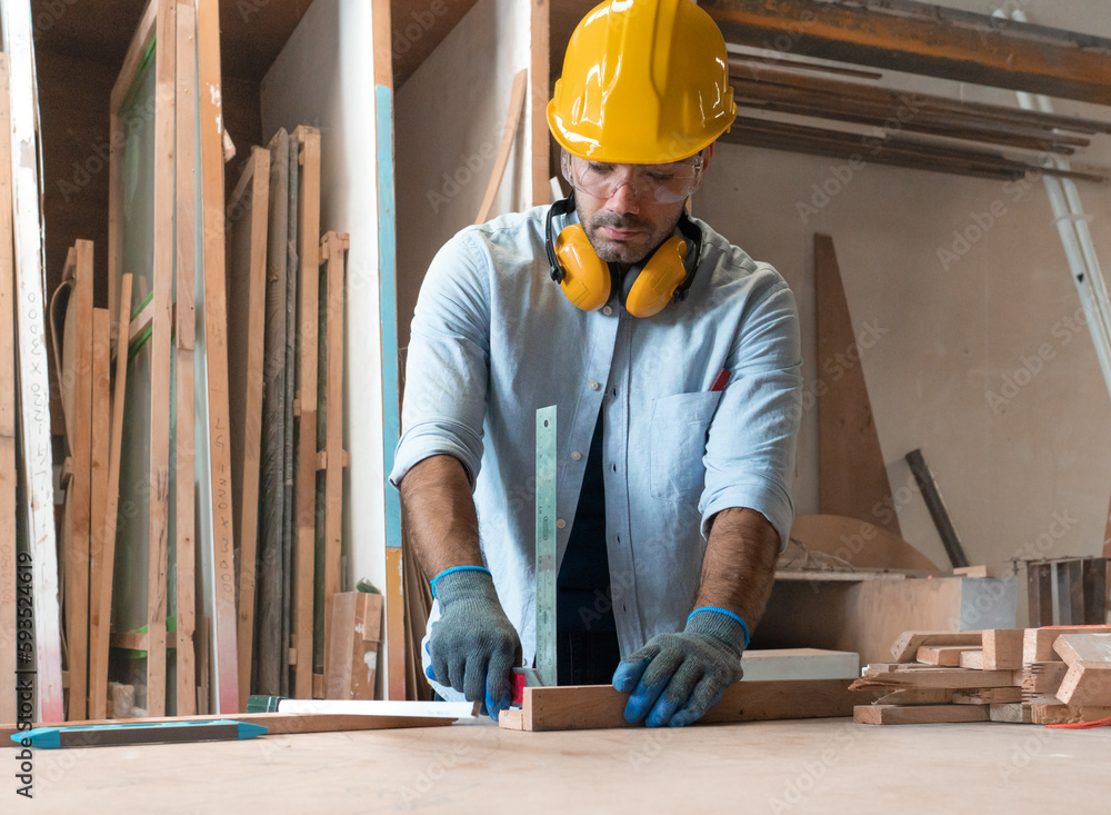 Male carpenter working with skill in carpentry workshop. Professional joiner work with manual tool equipment in woodwork. Portrait of woodworker making or repairing furniture. Craftsman industry. Male carpenter working with skill in carpentry workshop. Professional joiner work with manual tool equipment in woodwork. Portrait of woodworker making or repairing furniture. Craftsman industry.