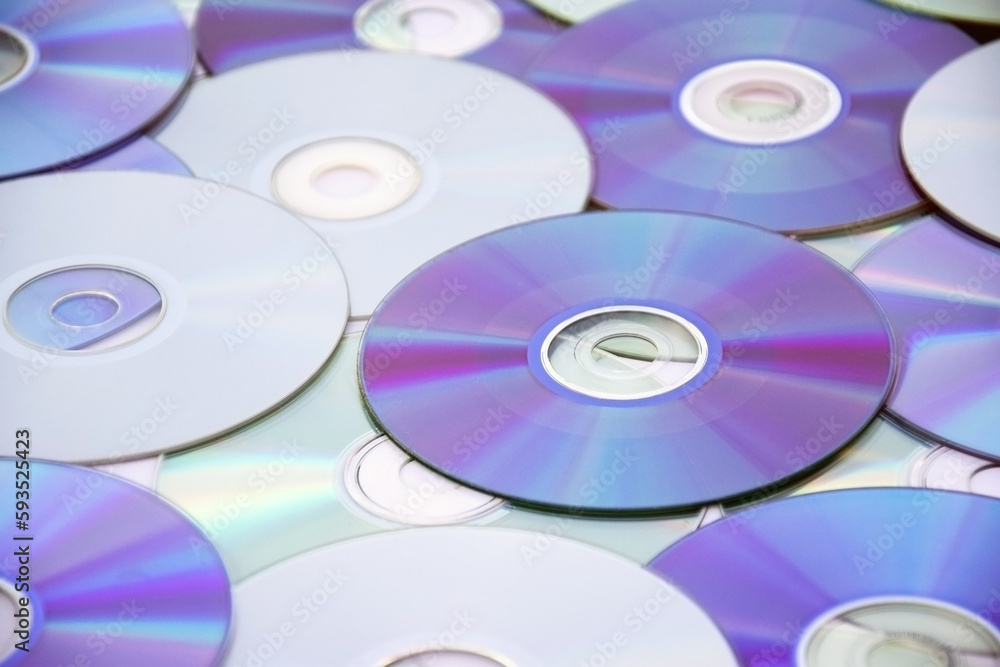 Lots of old CDs are laid out as a background. Lots of old CDs are laid out as a background.