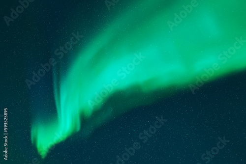 Night starry sky and Northern lights. Bright green aurora borealis