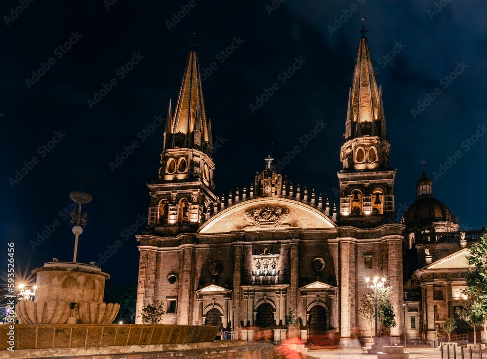 Mesmerizing skyline of Guadalajara Cathedral in Mexico captured under light against the night sky