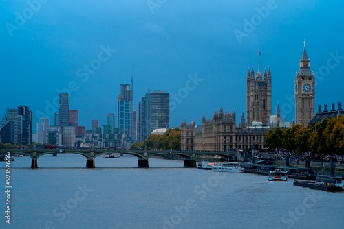Palace of Westminster and Big Ben with the skyline of London city at sunset
