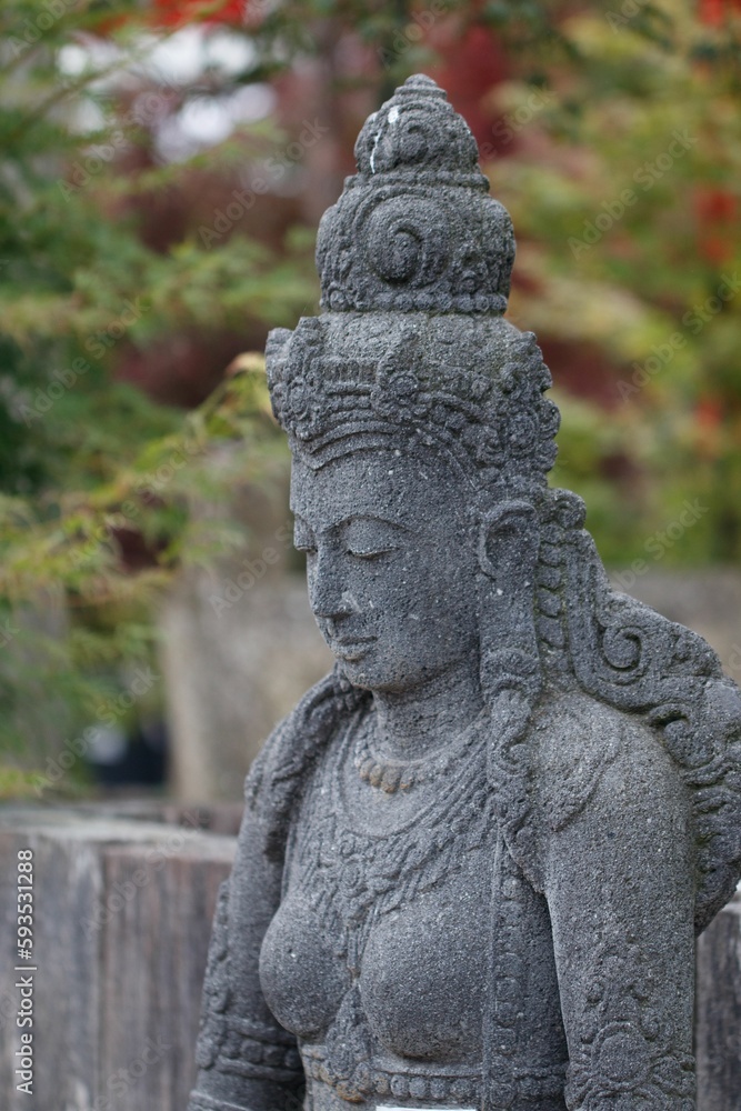 Vertical closeup shot of an Indian Goddess statue found in a garden