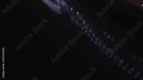 Hernado De Soto bridge in Memphis, Tennessee with illuminated Mighty Lights at night with drone video tilting up from Mississippi River. photo