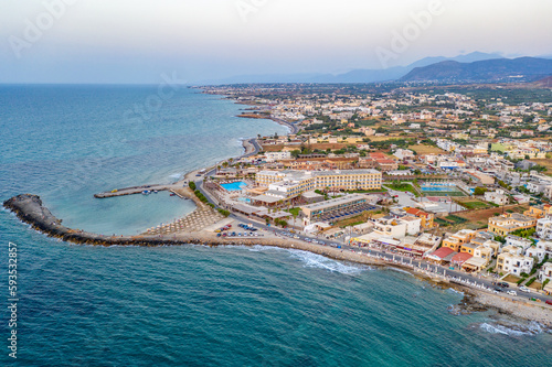 Marina Port Gouves - late afternno drone aerial photo, city landscape, buildings and blue water anb sandy beach