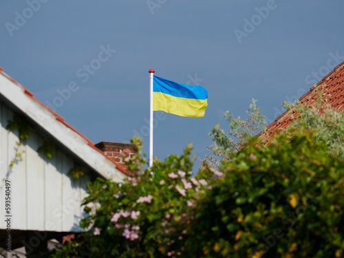 Ukrainian flag waving in background of sky