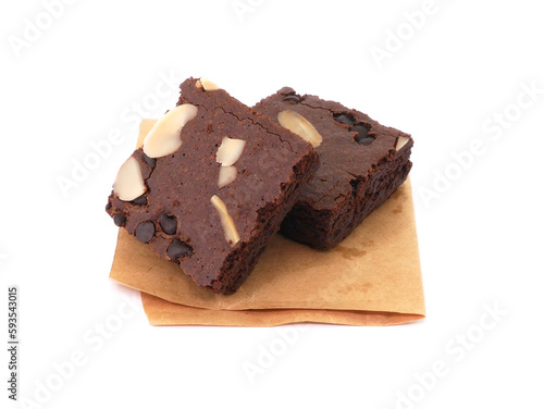 Brownies on paper isolated white background. Chocolate brownie with sliced almond nuts toppings. Chocolate Brownie pieces. selective focus.