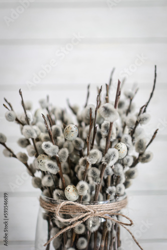 Easter postcard. bouquet of a small willow in a glass vase tied with twine, greeting card
