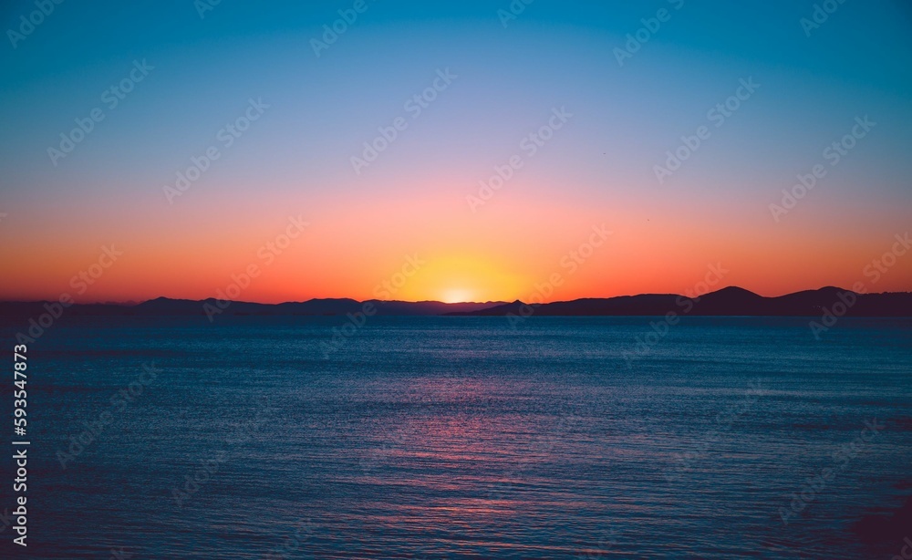 Drone shot of scenic sunset over the calm sea in the evening, cool for the background Drone shot of scenic sunset over the calm sea in the evening, cool for the background