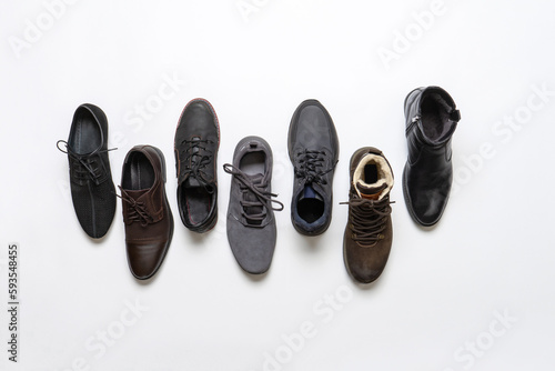 Men's shoes on white background. Pairs of men footwear for various seasons. Fashion collection of boots for man. Shoes store, advertising, shopping, sale concept. Flat lay, top view
