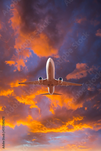 Airplane in the sky at amazing sunset