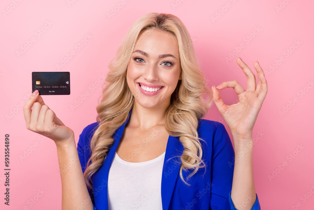 Photo of professional seo manager young beautiful lady smile show okey symbol hold plastic debit card good offer isolated on pink color background Photo of professional seo manager young beautiful lady smile show okey symbol hold plastic debit card good offer isolated on pink color background