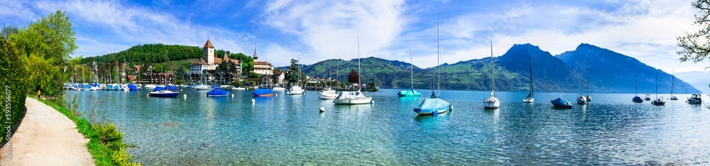 Scenic lake Thun and the Spiez village with its famous medieval castle and old town in the alps in Canton Bern in Switzerland