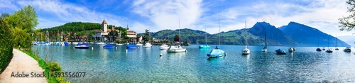 Scenic lake Thun and the Spiez village with its famous medieval castle and old town in the alps in Canton Bern in Switzerland © Freesurf