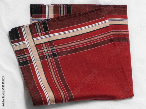 Vintage men's red striped handkerchief on white fabric.
