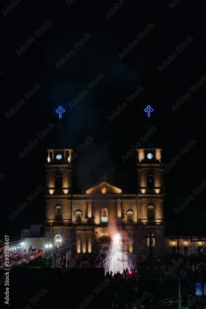 Vertical shot of fireworks in front of church during city's holidays of Tuxpan Jalisco, Mexico