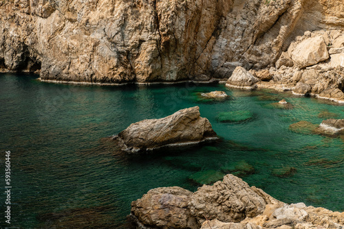 Hidden in the mountains is a bay with turquoise water. 