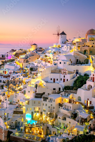 Romantic evening view of traditional Greek village Oia on Santorini island in Greece. Santorini is iconic travel destination in Greece, famous of its sunsets and traditional white architecture.