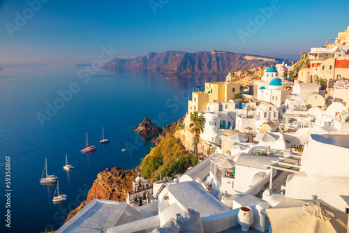 Famous Panoramic view of Santorini, Greece. White architecture, yachts and the blue sea of the island of Santorini against the background of the sea.