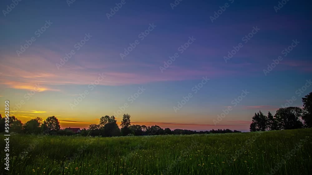 Timelapse of sunrise over lush green field. Static wide shot Timelapse of sunrise over lush green field. Static wide shot