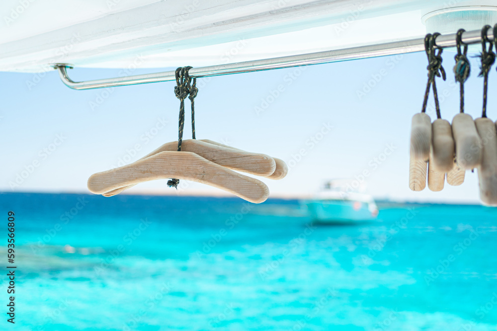 hangers for diving suits on the background of the sea
