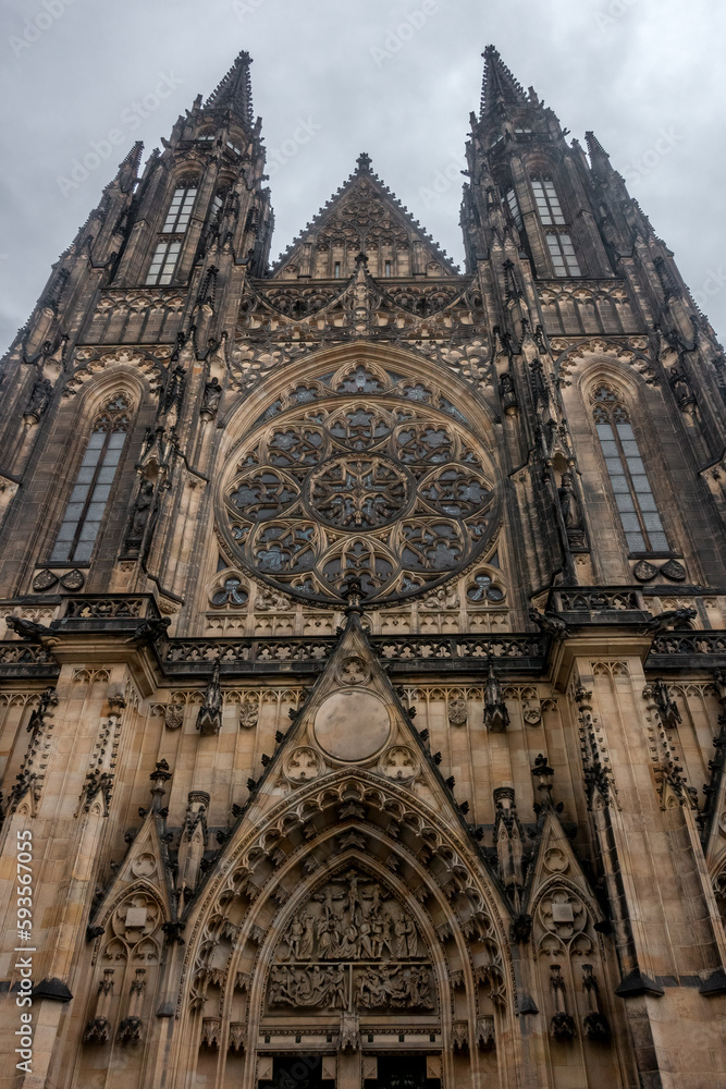 Low angle vertical shot of gothic St. Vitus cathedral in the city of Prague, Czech Republic. Majestic Christian religious architecture.