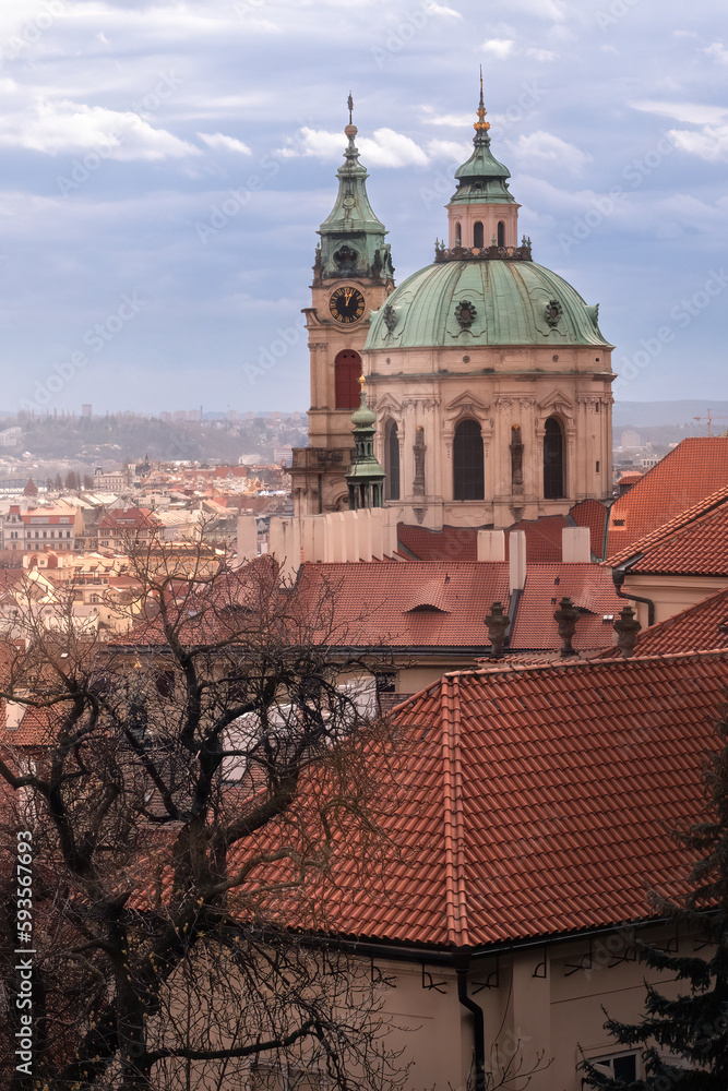 Romantic view of St.Nicholas church in the old town of Prague on a cloudy day of spring. Warm pastel colors. Most beautiful city in the world. Bucket list location. Spring in Czech capital.