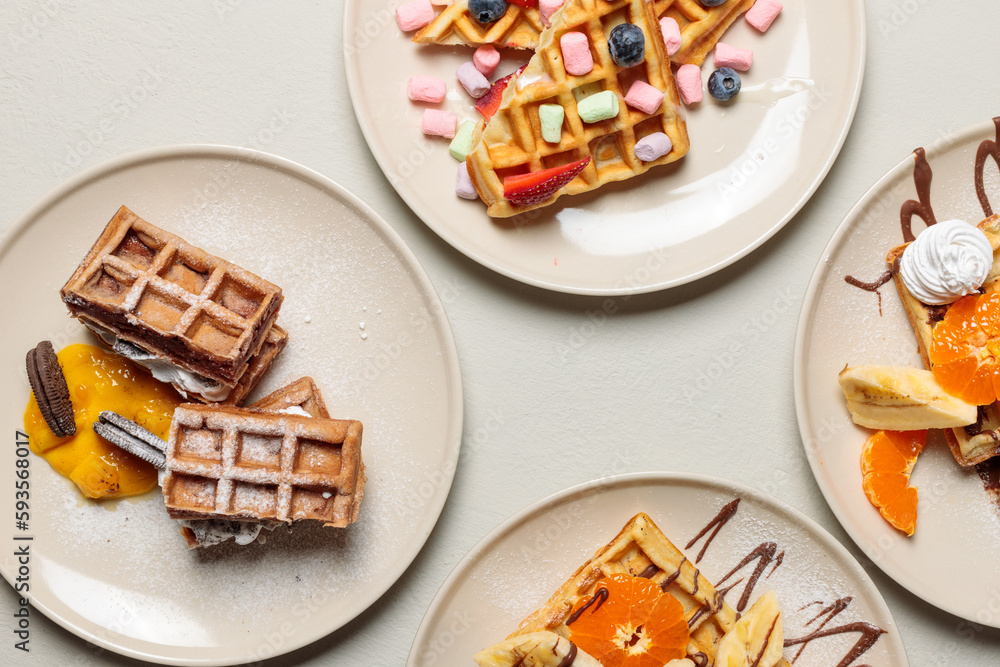 Breakfast, sweet Belgian waffles with fruit, cream and marshmallows. Top view on a light wooden surface, hard light. Screensaver, cover. Breakfast, sweet Belgian waffles with fruit, cream and marshmallows. Top view on a light wooden surface, hard light. Screensaver, cover.