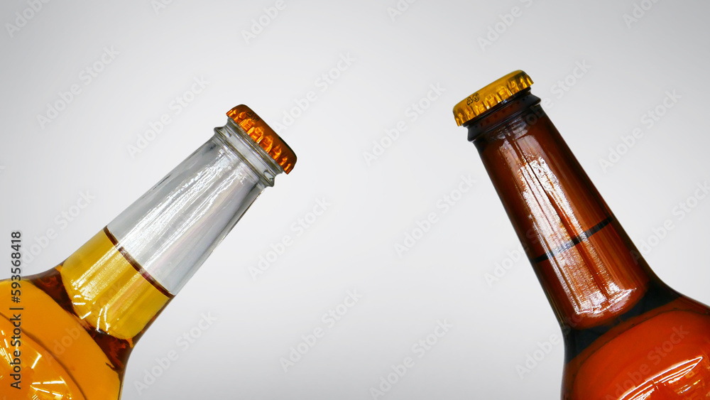 Two different bottles of beer against white background Two different bottles of beer against white background