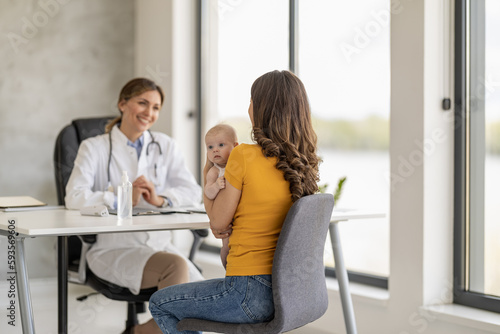Mother with little baby visiting pediatrician in clinic