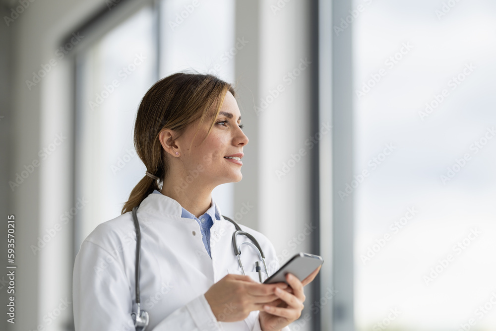 Portrait of female doctor in her office with smartphone Portrait of female doctor in her office with smartphone