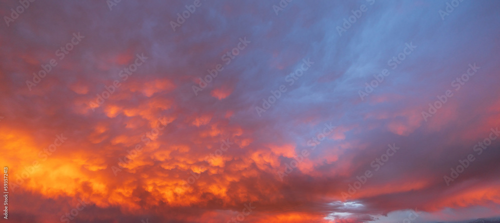 Panorama of morning sunrise with a perfect colorful sky and heavenly clouds.