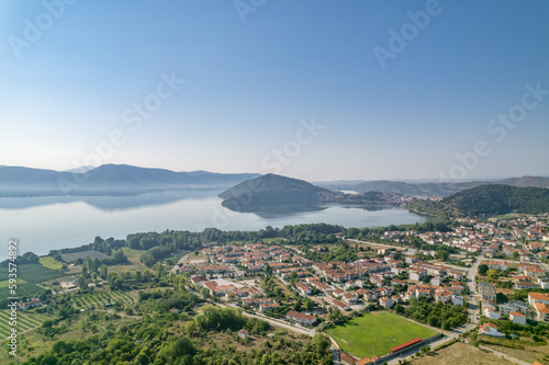 Landscape of countryside town  village and lake of Orestiada in Kastoria during summer sunny day over a mountain peak in Greece. Aerial  drone  top view. Panorama