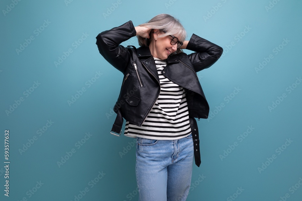 cheerful 60s mature woman in a stylish jacket on a bright background cheerful 60s mature woman in a stylish jacket on a bright background