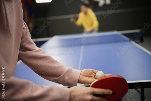 Принти на полотні Cropped view of man playing table tennis with blurred friend in gaming club