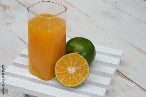 Orange juice. made from fresh squeezed oranges. tangerine. fresh fruit drink without preservatives, a source of natural vitamin C and antioxidants. served in clear glass. citrus nobilis.  photo