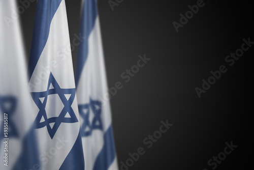 Israel flags with a star of David over dark gray background. Banner with place for text. photo