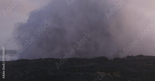 Huge wave crashing at Brimketill Iceland, slow motion cinematic photo