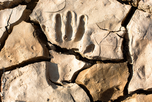 Close up of a handprint in dried mud photo