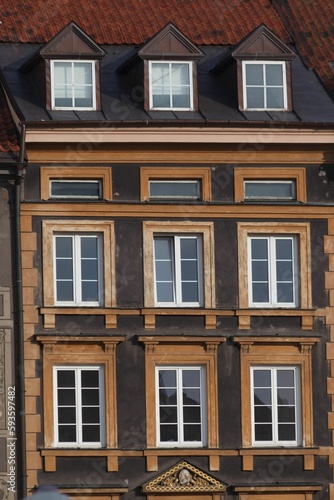 Vertical shot of detail of the adorned facade of a historical building in downtown Warsaw, Poland