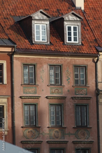 Vertical shot of detail of the adorned facade of a historical building in downtown Warsaw, Poland