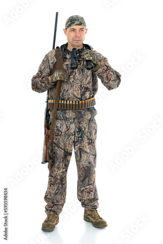 Full length portrait of a mature hunter with a shotgun, isolated on white background. Duck hunter with a rifle on his shoulder and binoculars looks to the side posing in studio.