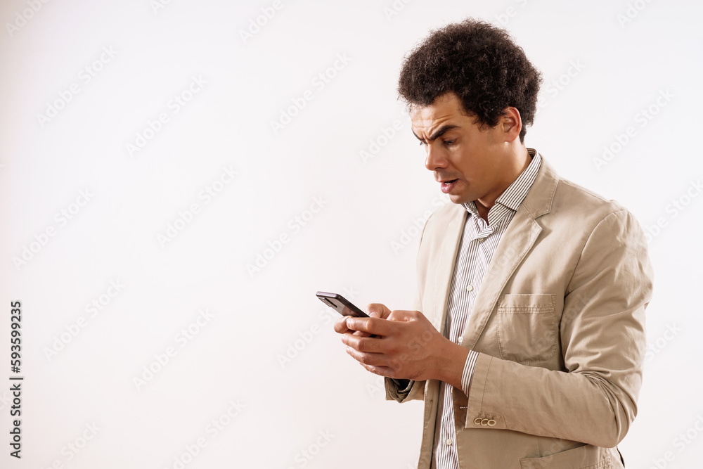 Image of shocked businessman using phone. Image of shocked businessman using phone.