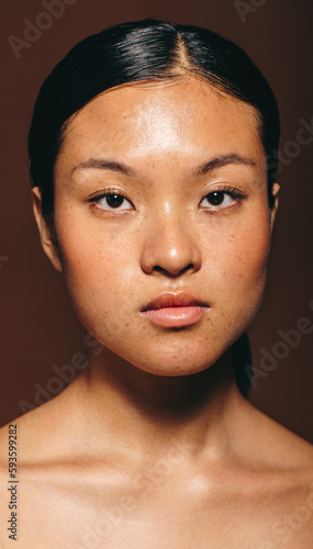 Confidence and radiance: Asian beauty looks at the camera in a studio