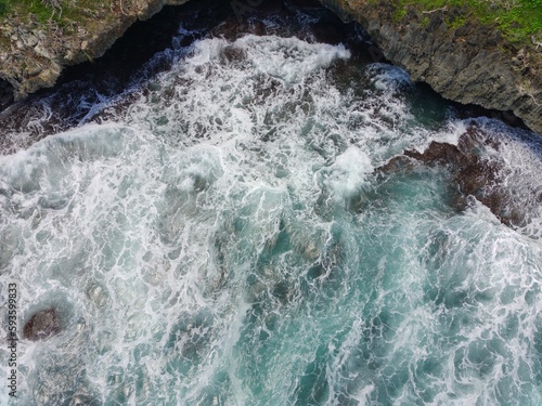 Aerial view of the waves hitting the coastal reefs