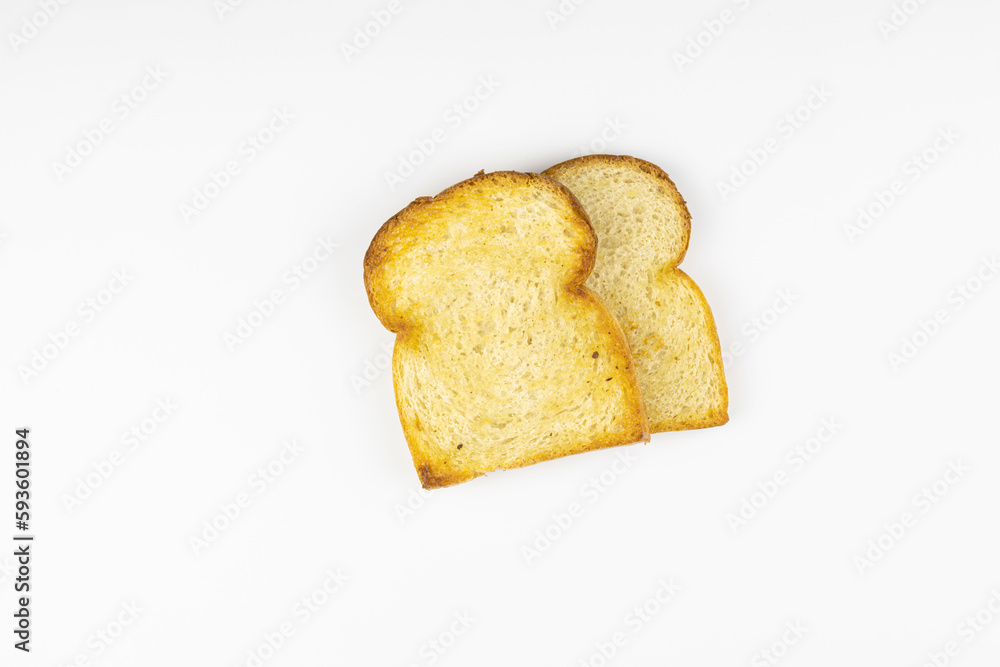 Two toasted slices of bread in isolation on a white background. Top view. Two toasted slices of bread in isolation on a white background. Top view.