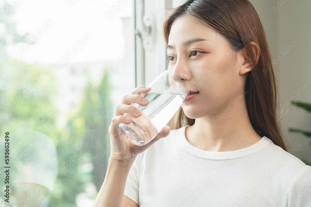 Clean freshwater concept. Woman drink mineral water in the morning for good health. Clean freshwater concept. Woman drink mineral water in the morning for good health.