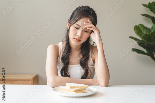 Φωτογραφία food intolerance concept, young women anxiety before eating bread worrying about gluten intolerance in the bread