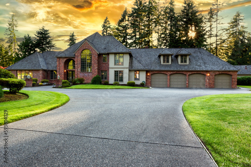 Beautiful luxury home exterior in early evening during golden sunset